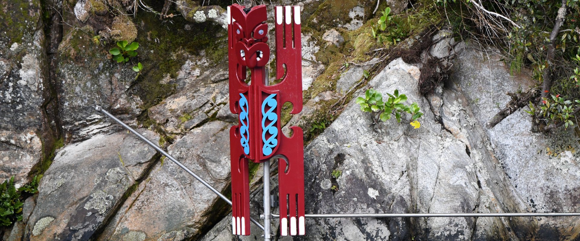Pou Marker on Coastal Rock Face